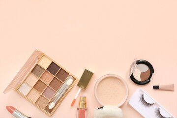 Fototapeta premium Cosmetic products for eyes makeup with lipsticks and powder on beige background