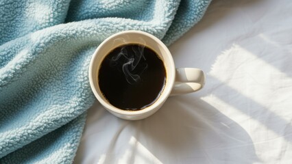 Black coffee in white mug on blue blanket under morning light Cozy, comforting mood for relaxation or morning routine