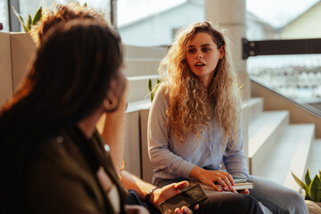 Young woman talking with colleagues during informal meeting in office