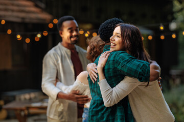Two people hugging in an outdoor setting