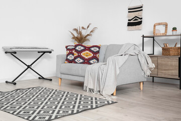 Interior of living room with sofa and synthesizer