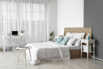 Interior of modern bedroom with workplace