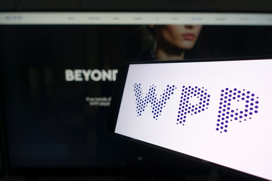 Kiel, SH, Germany March 24 2025: Smartphone displaying WPP logo in front of company website on a monitor, illustrating the intersection of technology and brand presence in marketing