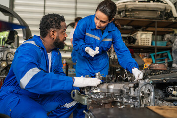 Team Auto mechanic are checking and repair maintenance auto engine is problems at car repair shop.