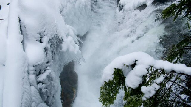 Raging Waterfall in Snowy Winter Landscape at Deception Falls Washington