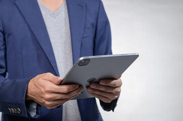 Businessman Holding Tablet in Smart Casual Attire Indoor Setting
