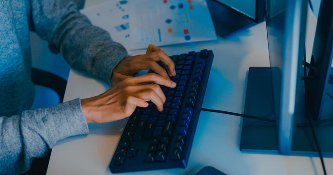 Closeup young adult Asia male freelance typing write prompt AI bot IT app smart program nomad, video game, terminal with coding language, designer, big data center on desktop computer in night office.