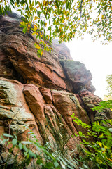 View of the Hahnfels near Erfweiler in the Palatinate region with the surrounding nature. Landscape with hiking trails on the red sandstone cliff.
