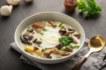 Homemade Kulajda is  traditional Czech thick soup, with mushrooms, potatoes, cream and poached egg  in bowl
