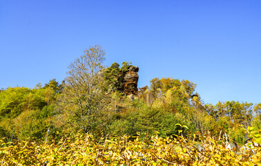 View of the Hebefels near Erfweiler in the Palatinate region with the surrounding nature. Landscape with red sandstone cliff.
