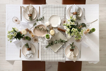 Beautiful table setting with eustoma flowers and eucalyptus for wedding celebration in room, top...