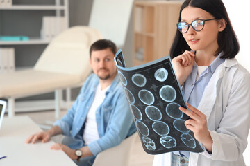 Female doctor studying patient's MRI scan in clinic