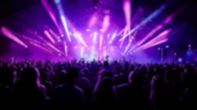Blurred shot in a nightclub with beams of light and a dancing crowd