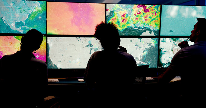 People, screen or monitor with weather for forecast, satellite maps or teamwork to track storm. Control room, back or scientists with meteorology for broadcast news, report or climate change at night