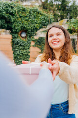 Happy daughter receiving gift from her mother in a garden