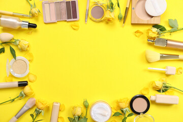 Frame made of flowers and decorative cosmetics on yellow background