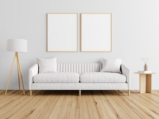 Stylish and modern living room with a white sofa, wooden floor, and blank frames.