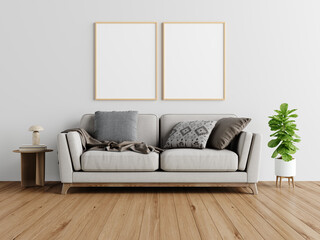 Modern living room with sofa, blank frames, and wooden floor