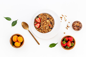 Flat lay of oatmeal granola and ingredients served on white table. Healthy breakfast