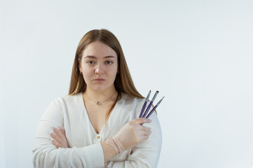 Fototapeta premium Makeup artist, young woman in studio with brushes in hands in gloves, product or tools for skin. Cosmetic, woman and model with beauty equipment for face cosmetology treatment.