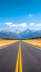 Fototapeta premium Open road vanishing into majestic mountains under a clear blue sky