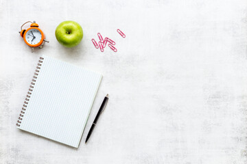 Back to school concept. Blank sheet of notebook with supplies, top view