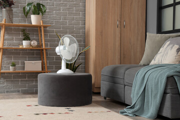 Electric fan on ottoman at home