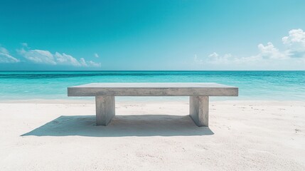 Fototapeta premium Solid concrete table resting on warm beach sand, crystal-clear ocean backdrop, vibrant blue sky overhead 