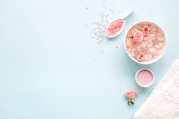 Beauty routine concept. Facial roses essence water and face cream with pink flowers and petals, top view