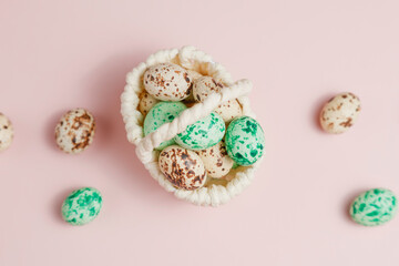 Easter eggsin basket on pink background with tulips.
