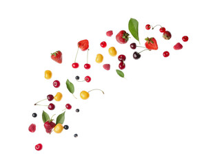 Flying different fresh berries with leaves on white background