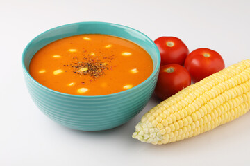 tomato soup with sweet corn on white background