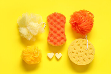 Composition with different bath sponges on yellow background