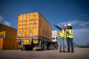 Engineer or dockworker working in the construction container dock yard checking and inspection...