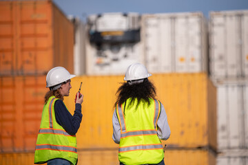 Engineer or dockworker working in the construction container dock yard checking and inspection...