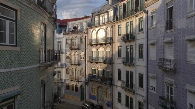 Azulejo Fascades on a Curvy Street in Lisbon. Aerial Shot of Traditional Portuguese Houses decorated with Ceramic Tiles