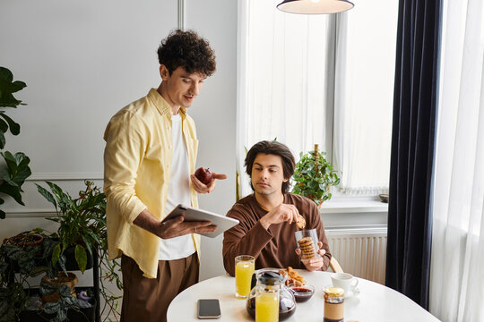 Modern love in a cozy apartment shared by a happy gay couple enjoying breakfast together