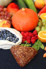 Various healthy fruits, vegetables and cereals on dark background. Selective focus.
