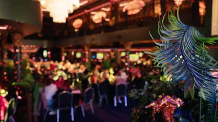 A vibrant restaurant atmosphere characterized by a blurry background filled with colorful, inviting lights