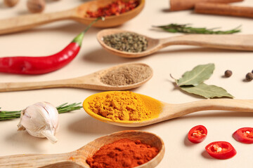 Composition with wooden spoons of fresh aromatic spices on color background