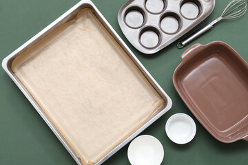 Composition with baking tray for oven and different kitchen utensils on color background