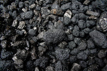 Pile of black coal stones with roughness and bulging on the outside, intended as fuel for domestic or industrial use, extracted from the mining basins of Asturias