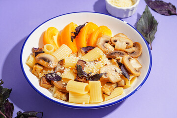 Plate with delicious Italian pasta salad on violet background