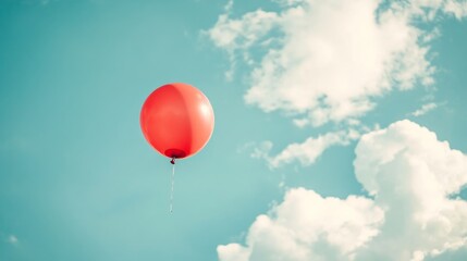 Obraz premium Red Balloon Soaring in a Pastel Sky