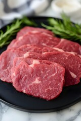 Raw Beef Steaks on Black Plate with Rosemary