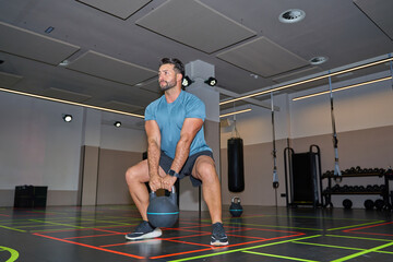 Man exercising with medicine ball in modern gym