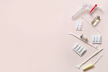 Set of gynecological supplies on beige background