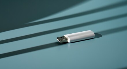 White USB flash drive on teal surface with shadows