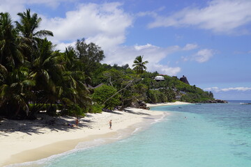 The white sandy Anse Forbans Beach with the blue turquoise Indian Ocean in the background on...