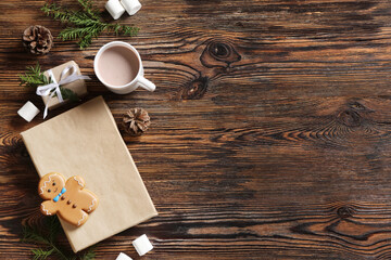 Composition with book, cup of cocoa drink, Christmas cookie and fir branches on wooden background
